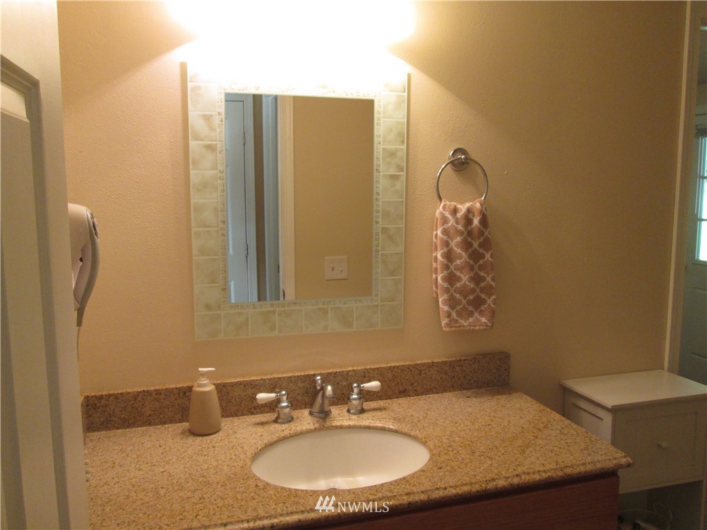 18905 Rouse Road Southwest Longbranch, WA 98351 - Photo 14 of 25 a bathroom with a sink and a mirror