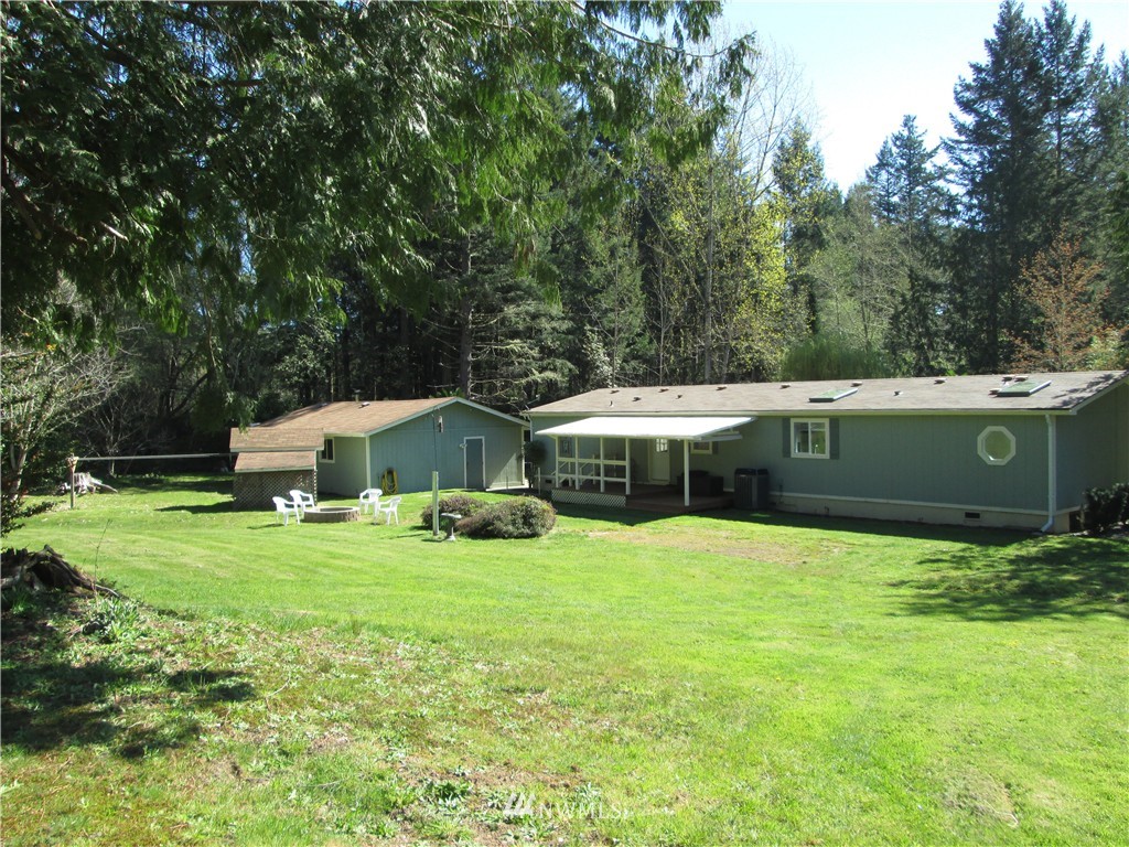 18905 Rouse Road Southwest Longbranch, WA 98351 - Photo 18 of 25 a view of a house with a yard and sitting area