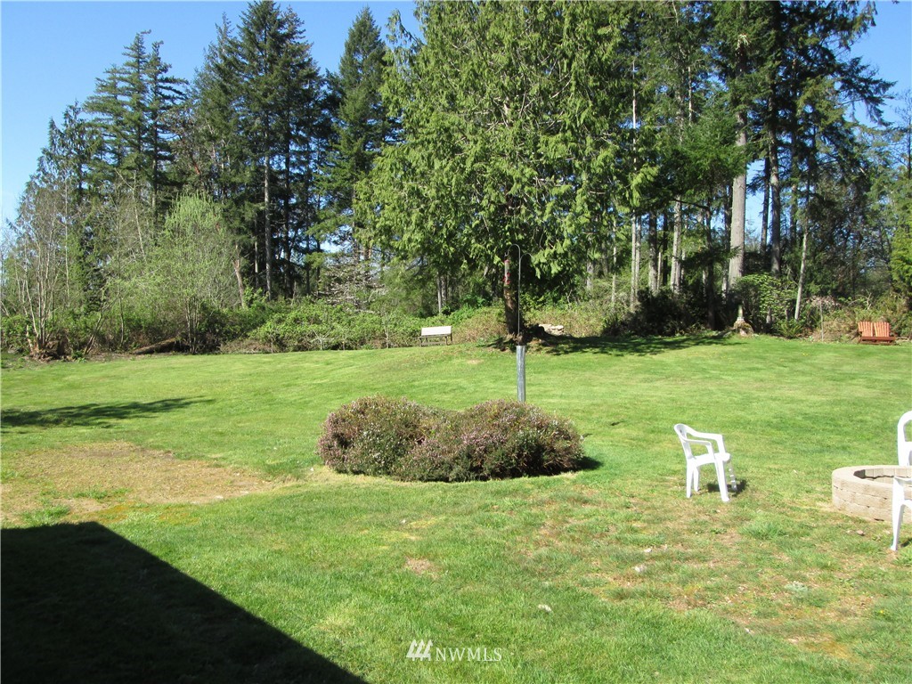 18905 Rouse Road Southwest Longbranch, WA 98351 - Photo 19 of 25 a backyard of a house with lots of green space