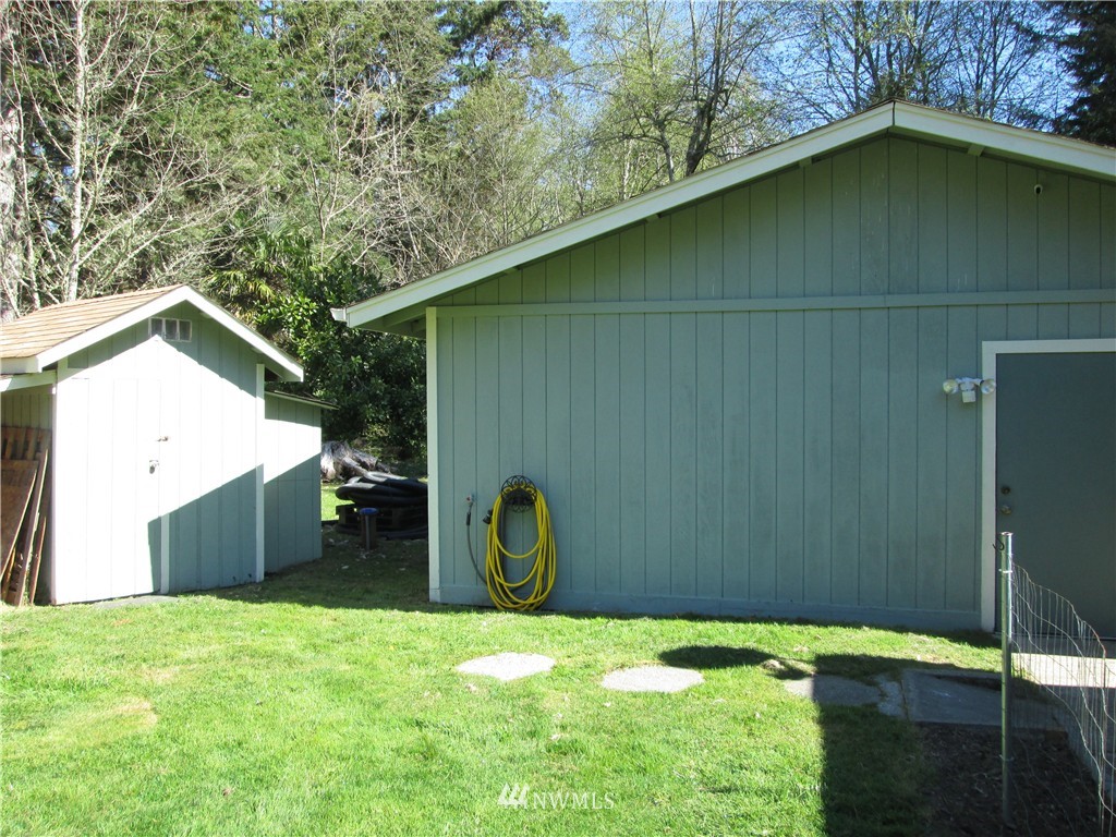 18905 Rouse Road Southwest Longbranch, WA 98351 - Photo 20 of 25 a backyard of a house with a yard and garage