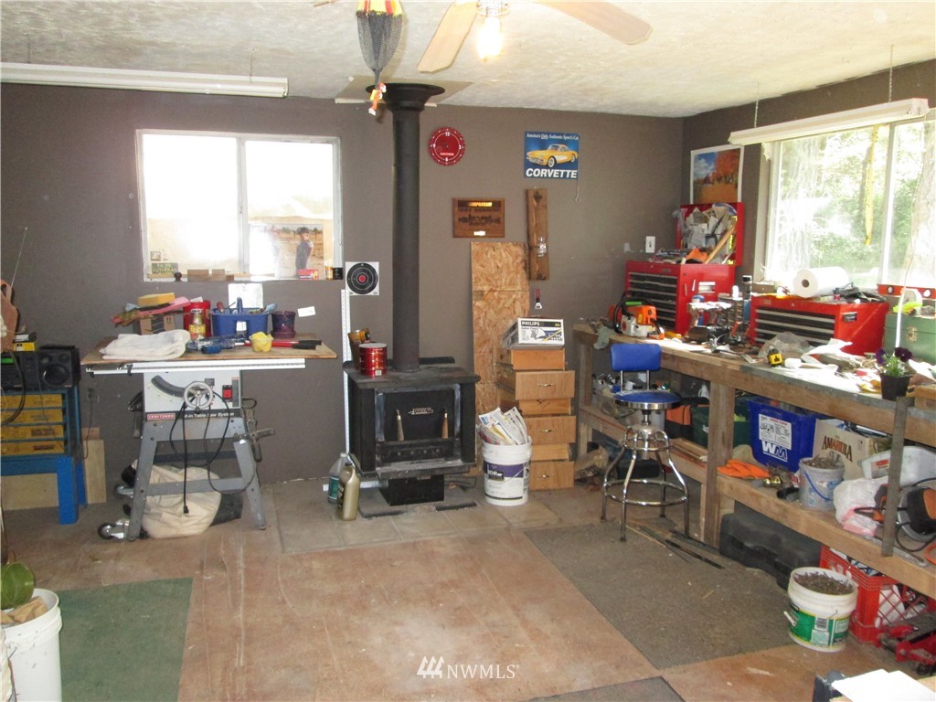 18905 Rouse Road Southwest Longbranch, WA 98351 - Photo 22 of 25 a room filled with furniture and a window