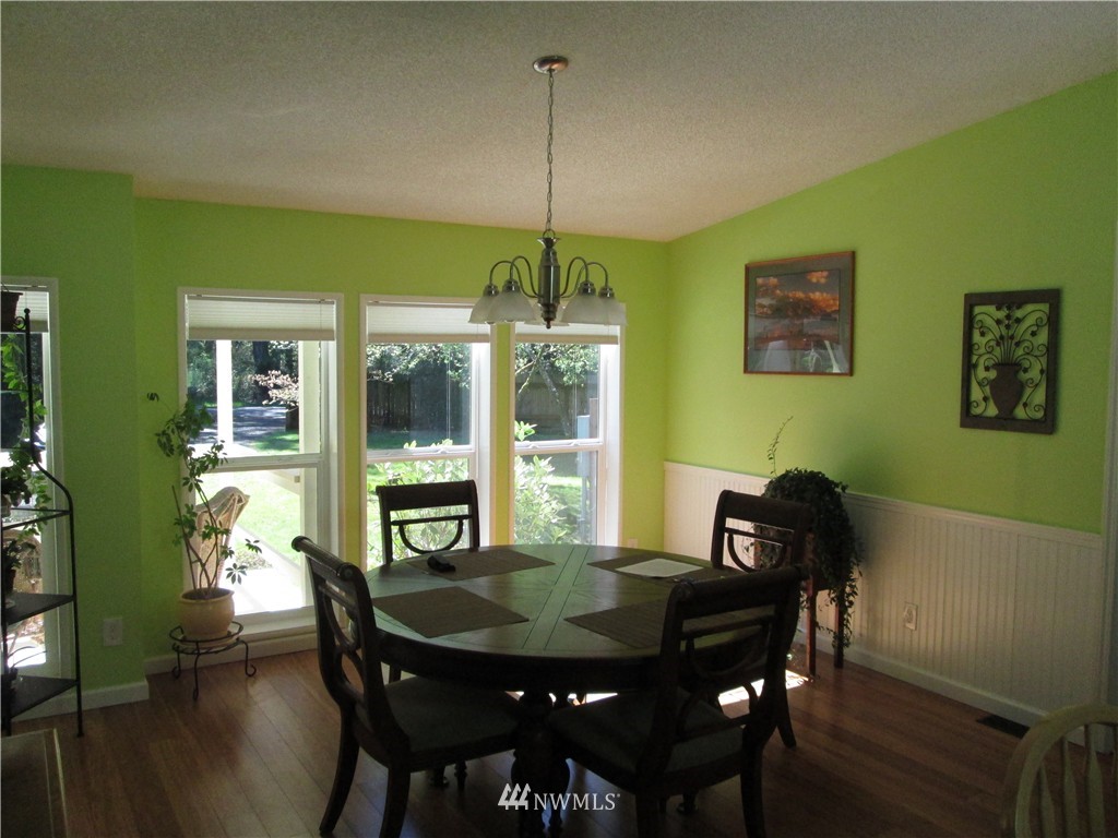 18905 Rouse Road Southwest Longbranch, WA 98351 - Photo 4 of 25 a view of a dining room with furniture window and wooden floor