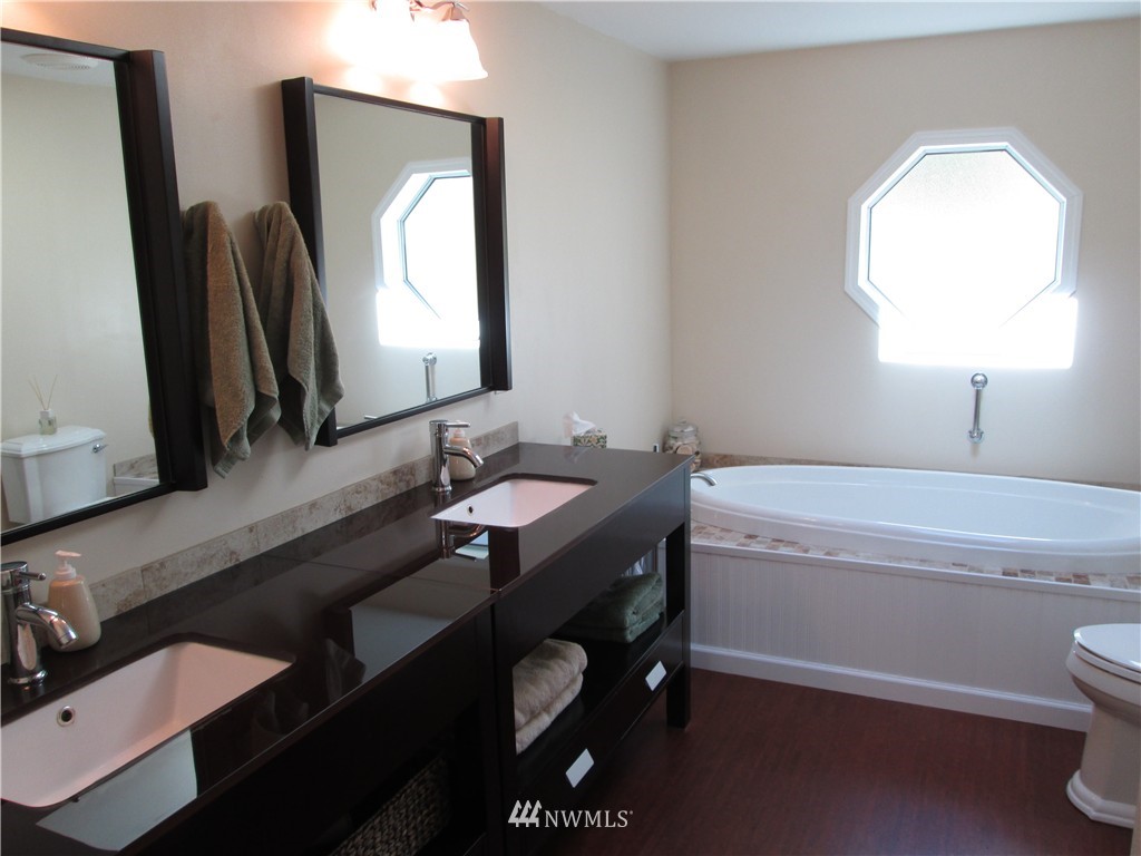 18905 Rouse Road Southwest Longbranch, WA 98351 - Photo 9 of 25 a bathroom with a double vanity sink and a mirror