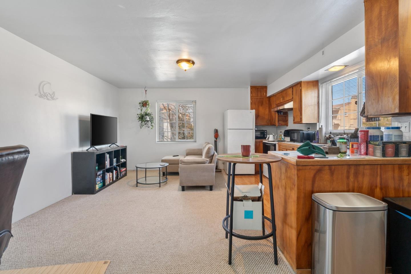 321 Second Street Santa Cruz, CA 95060 - Photo 26 of 34 a living room with furniture a flat screen tv and a fireplace