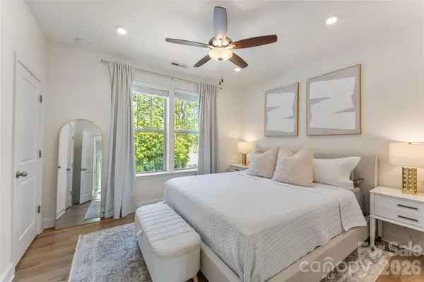 a bedroom with a bed and a large window