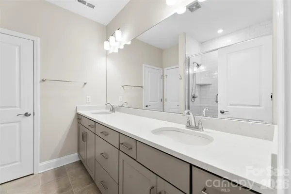 a bathroom with a sink double vanity and a mirror