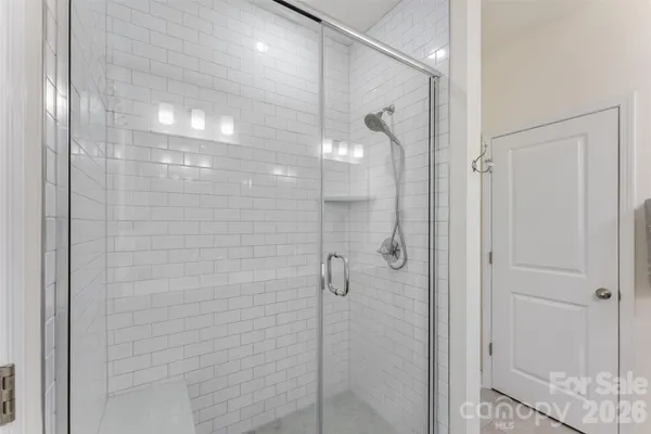 a bathroom with a glass shower door
