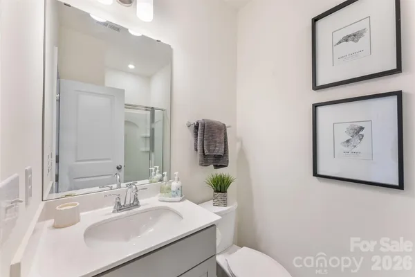 a bathroom with a sink mirror and toilet