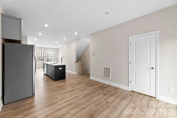 a kitchen with stainless steel appliances a refrigerator and a stove top oven
