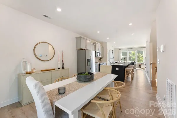 a dining room with furniture and a mirror