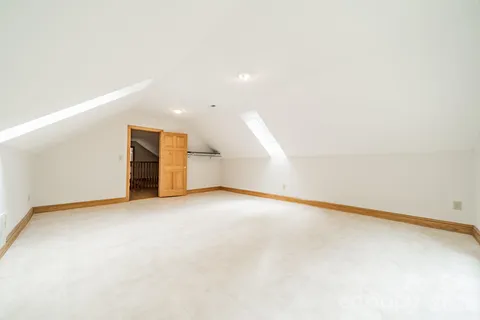 a view of an empty room with a kitchen