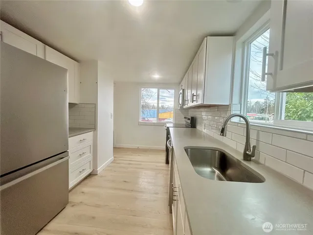 a kitchen with a sink cabinets and window