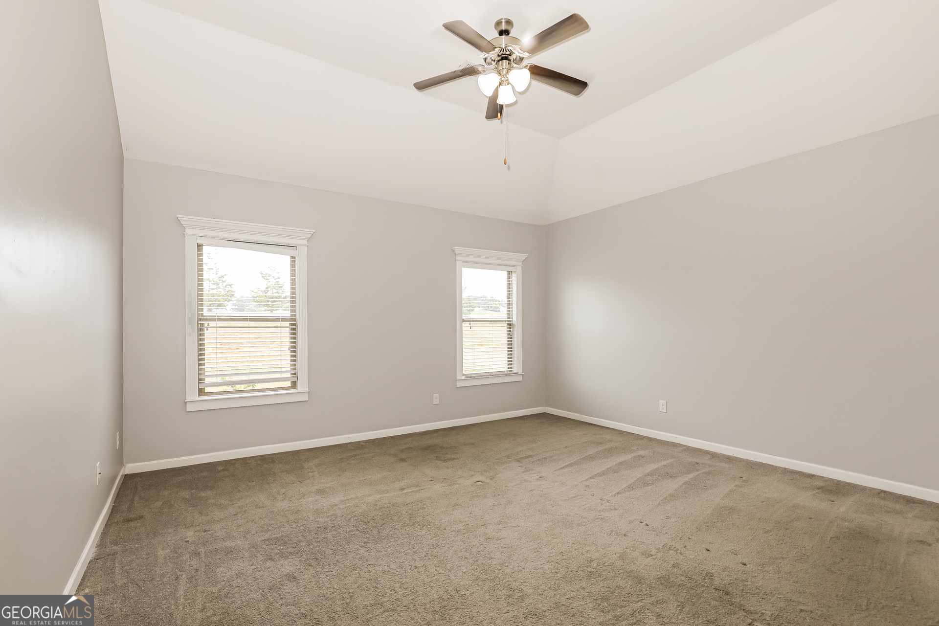 3216 Alhambra Circle Hampton, GA 30228 - Photo 10 of 21 an empty room with a window and a fan