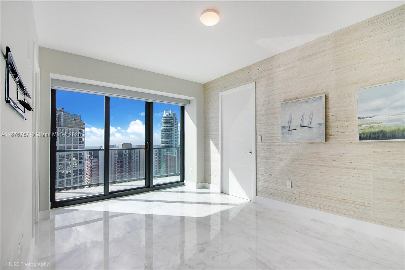 1451 Brickell Avenue, Unit 3102 Miami, FL 33131 - Photo 11 of 25 a view of an empty room with glass door
