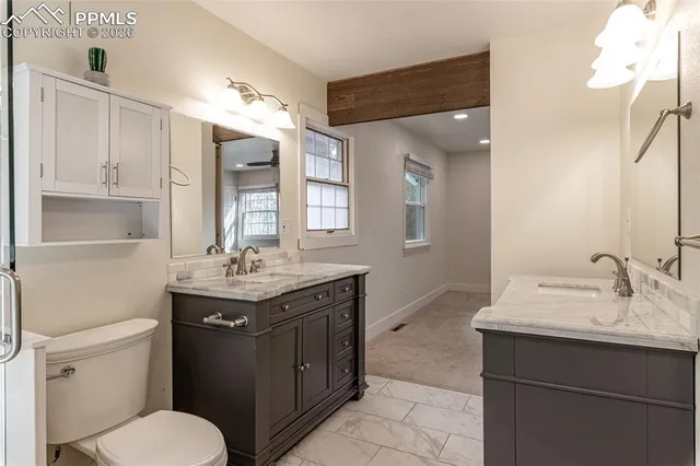 a bathroom with a toilet sink and mirror