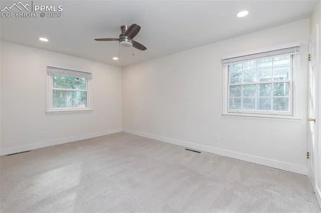 a bathroom with a granite countertop toilet sink and mirror