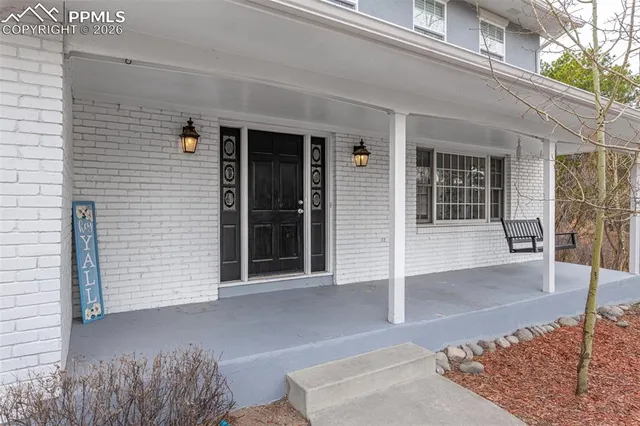 front view of a brick house with a large window