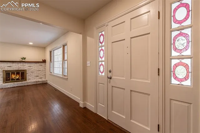 a view of an entryway with wooden floor