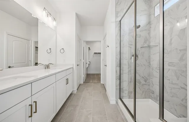 a spacious bathroom with a shower and a sink