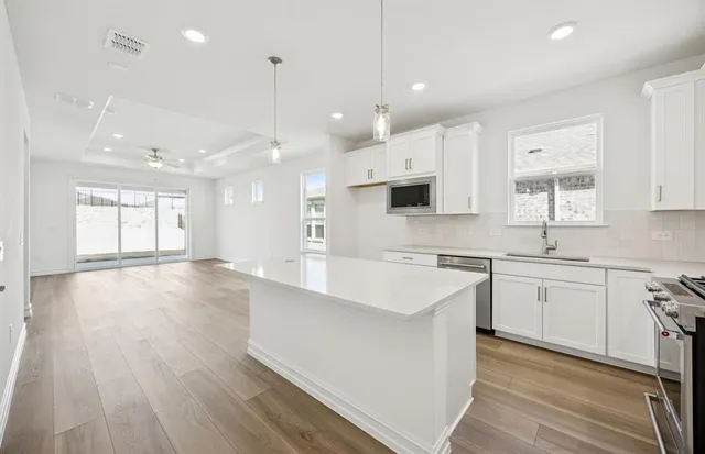 a large kitchen with stainless steel appliances kitchen island a large island in the center