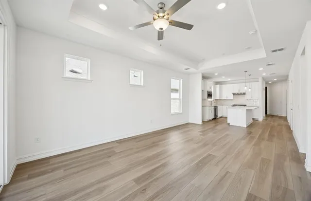 a view of a kitchen with wooden floor and a kitchen space