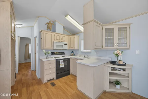 a kitchen with a sink stove and cabinets