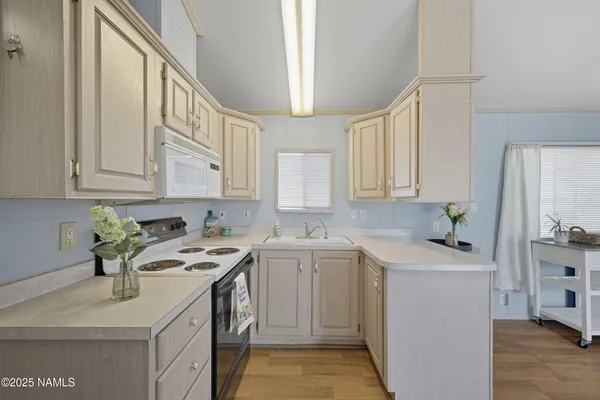 a kitchen with a sink stove and cabinets