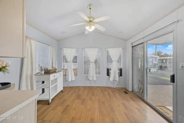 a spacious bathroom with a granite countertop sink a mirror a vanity and a shower