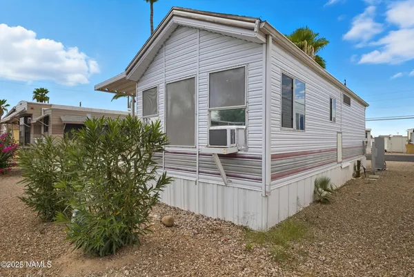 a view of a house with wooden fence