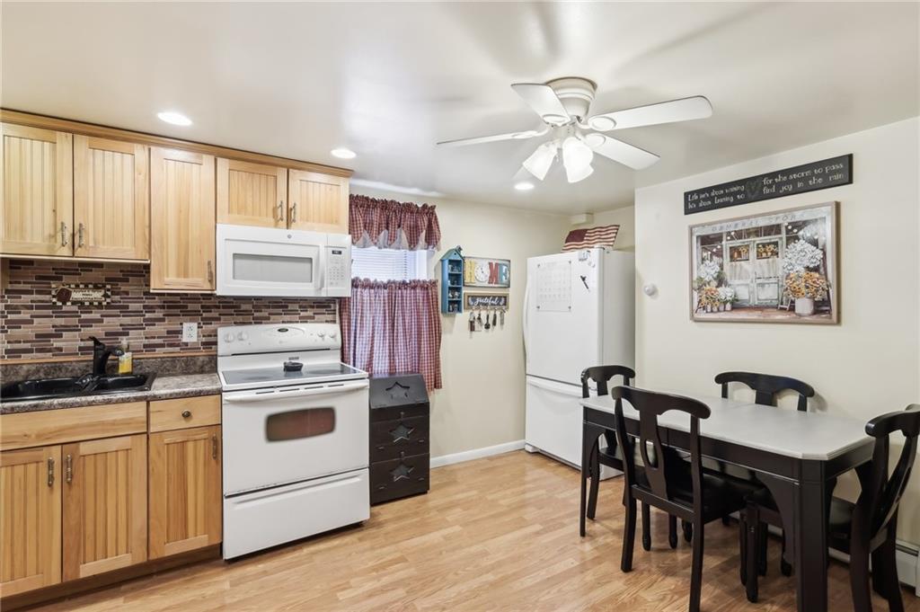 199 Latimer Avenue Strabane, PA 15363 - Photo 17 of 44 a kitchen with stainless steel appliances a white stove top oven and a refrigerator