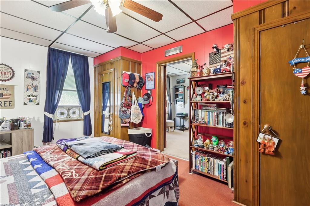 199 Latimer Avenue Strabane, PA 15363 - Photo 32 of 44 a bedroom with a bed a dresser and book shelf