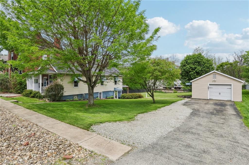 199 Latimer Avenue Strabane, PA 15363 - Photo 5 of 44 a view of a house with a yard and large trees