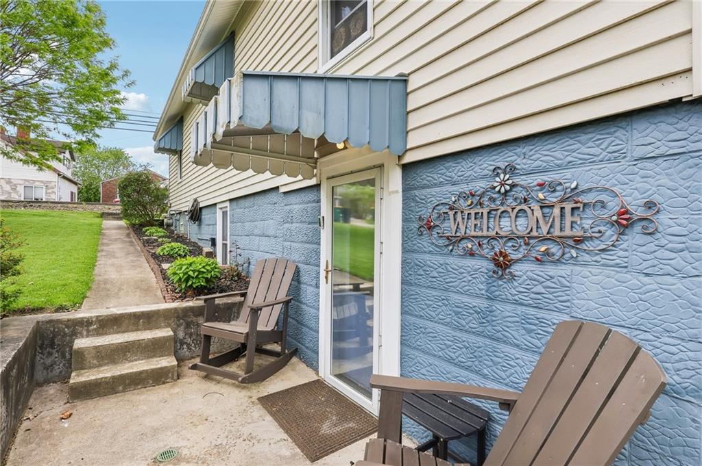 199 Latimer Avenue Strabane, PA 15363 - Photo 7 of 44 a view of a patio with table and chairs with wooden fence and plants