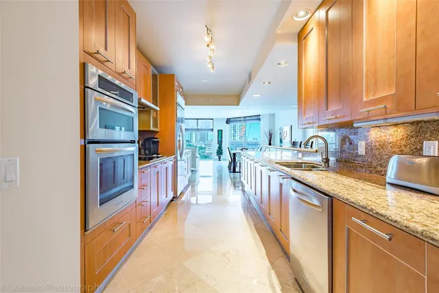 a bathroom with a granite countertop sink and a large window