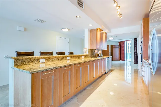 a bedroom with a balcony a bed and a flat screen tv