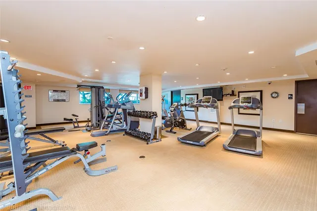 a view of a multi story residential apartment building with a yard