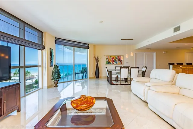 a living room with furniture and a floor to ceiling window
