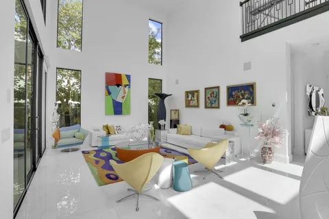 a view of a house with pool table and chairs