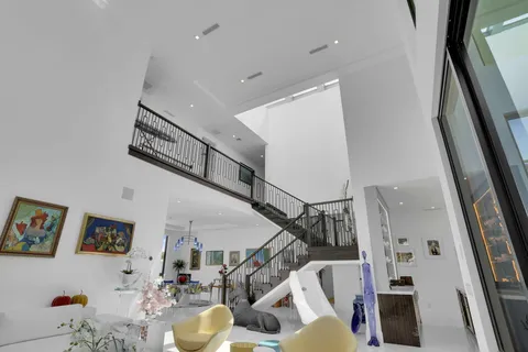 a view of an house with swimming pool and porch with furniture