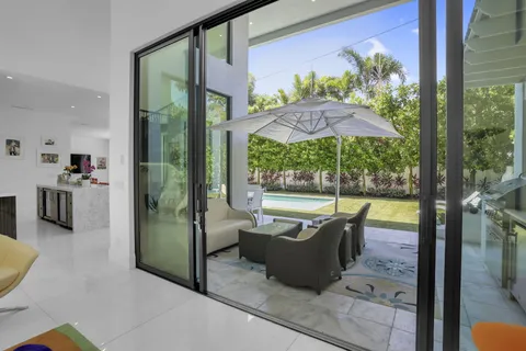 a view of a patio with a table and chairs under an umbrella