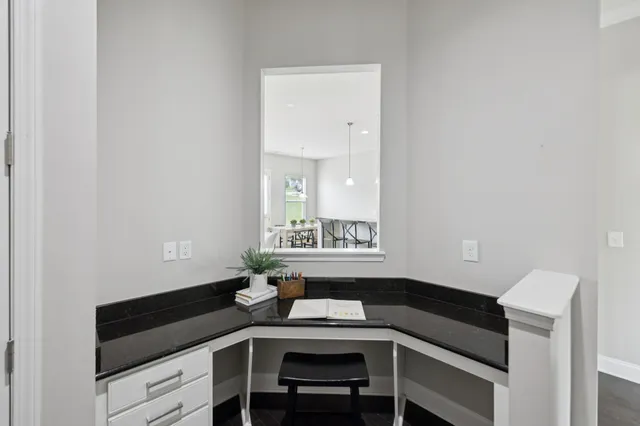a living room with furniture a fireplace and a large window