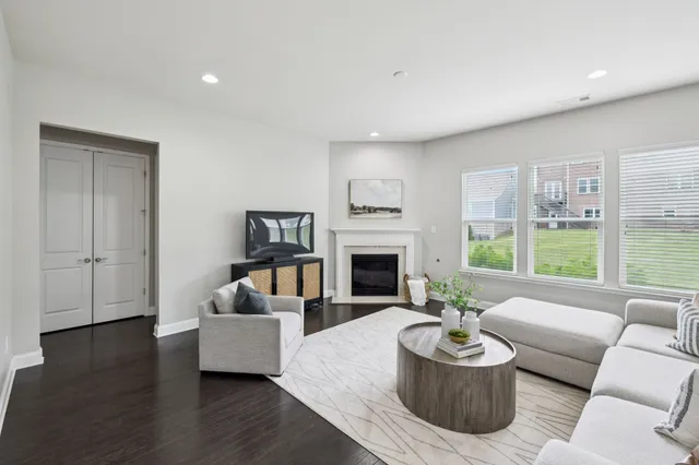a living room with furniture a fireplace and a window