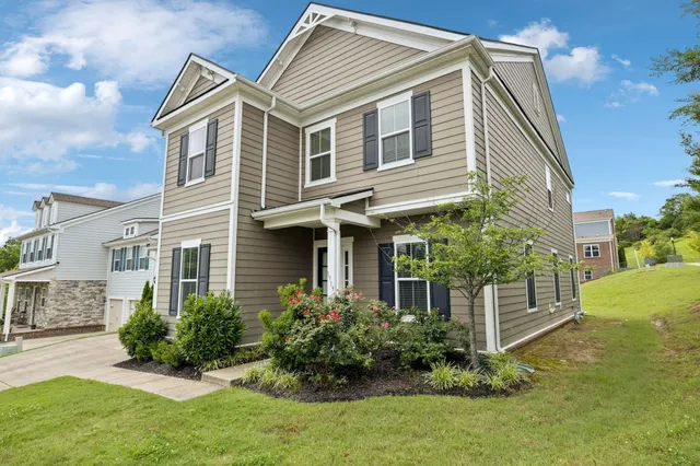 a view of a house with a yard and plants