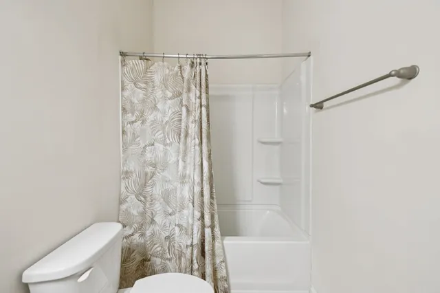 a bed room with a bed and a window