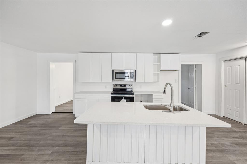 3847 Stalcup Road Fort Worth, TX 76119 - Photo 11 of 30 a kitchen with kitchen island a sink appliances and cabinets