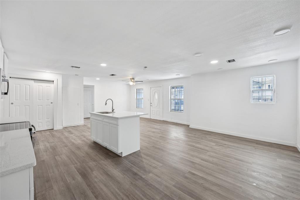 3847 Stalcup Road Fort Worth, TX 76119 - Photo 13 of 30 a view of a kitchen with wooden floor and a sink