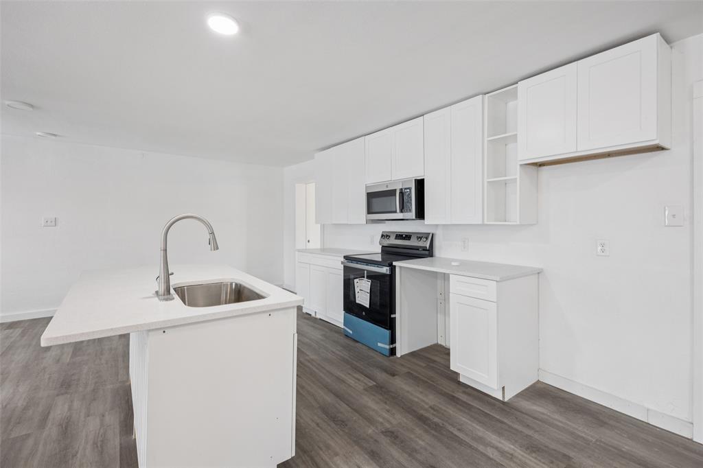 3847 Stalcup Road Fort Worth, TX 76119 - Photo 15 of 30 a kitchen with sink a microwave and stove