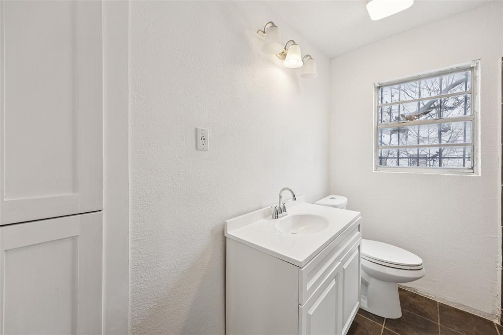 3847 Stalcup Road Fort Worth, TX 76119 - Photo 24 of 30 a bathroom with a sink toilet and a window
