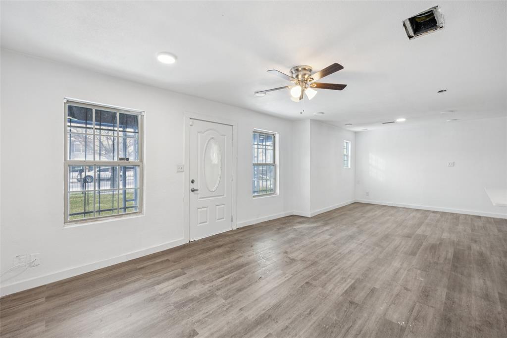 3847 Stalcup Road Fort Worth, TX 76119 - Photo 7 of 30 wooden floor in an empty room with a window