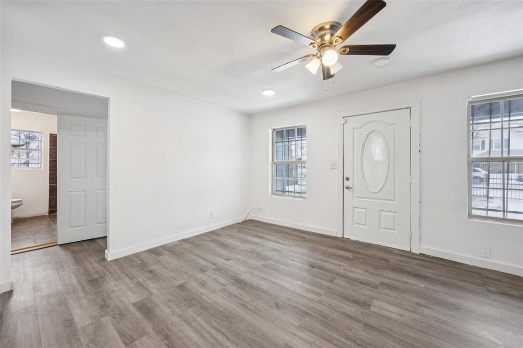 3847 Stalcup Road Fort Worth, TX 76119 - Photo 8 of 30 an empty room with windows and a ceiling fan